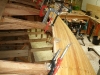 Strip planking edge nailed and clamped to frames